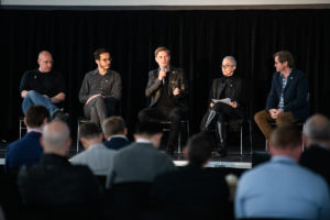A Photo Of Some Of Astra's Management Team Seated On Stage And Taking Audience Questions.